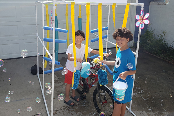 boys playing with homemade carwash