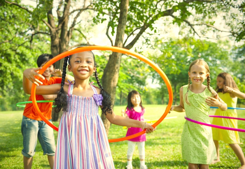 cute diverse kids playing with hula hoops NT5EF8M copy