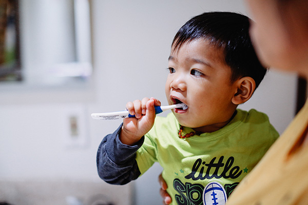 boy learning to brush teeth 2428