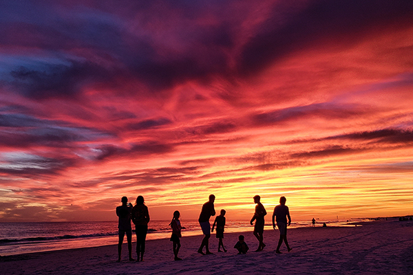 silhouetted family members on sandy beach watching 2022 11 12 09 54 27 utc