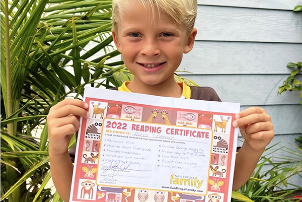 boy holding reading certificate