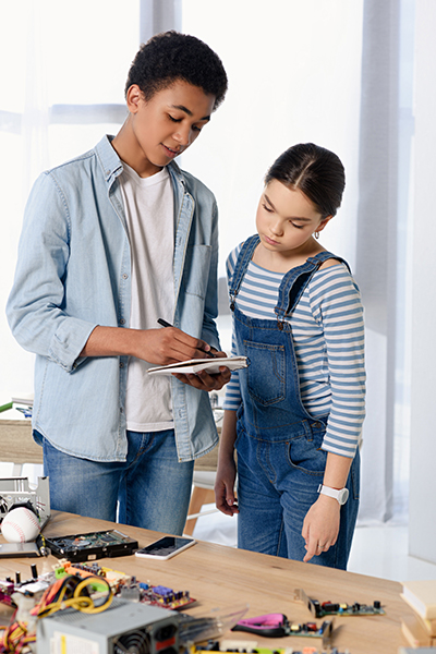 multicultural friends looking at notebook at home