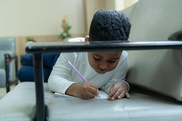 little boy with imagination who scribbled or drew what they thought on the paper with joy and fun