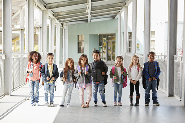 elementary school class standing in corridor