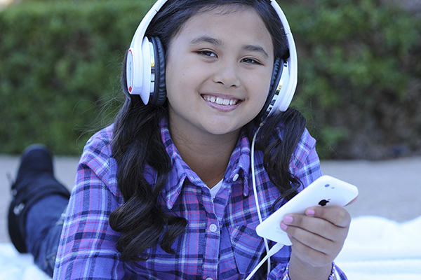 Girl listening to her music through headphones.